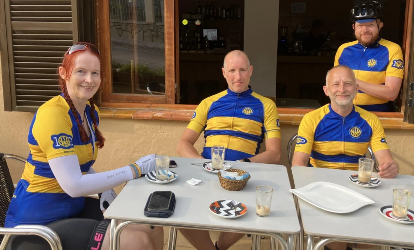 Club members in blue and gold kit at a cafe stop
